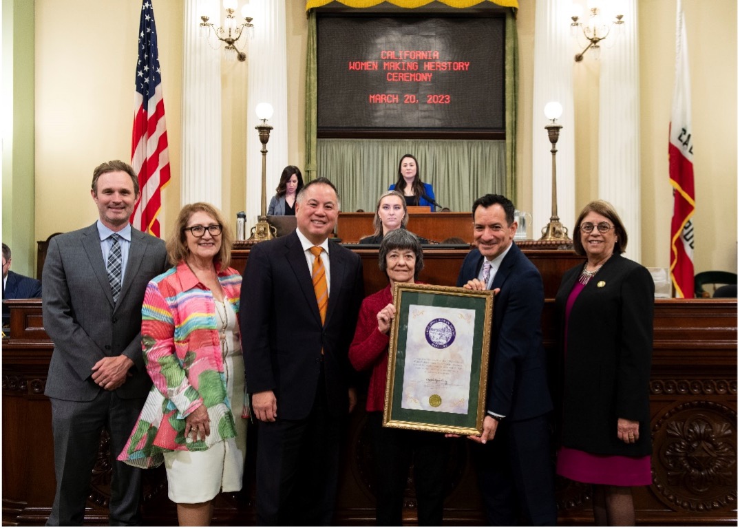Ting presents Dr. Alicia Boccellari (middle right) with a resolution on the Assembly Floor during the annual Woman of the Year celebration